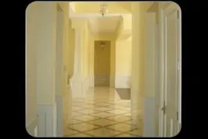 A white corridor with a tiled floor